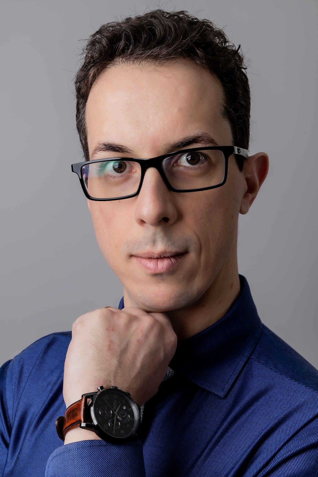 Retrato do Dr. André Andrade de camisa azul, com expressão concentrada
